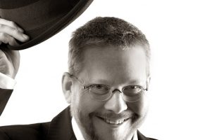 man tipping his hat in respectful greeting