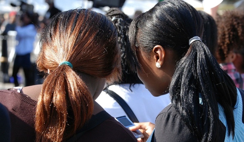 two young girls with ponytails