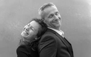 couple standing back to back