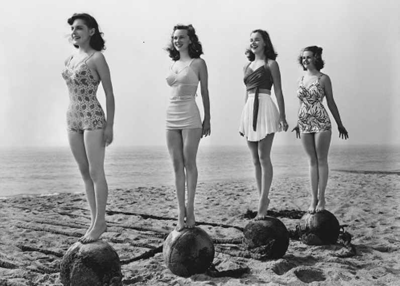 four women standing tall on exercise balls