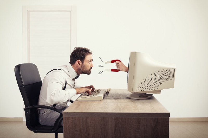commical picture of man hunched over computer