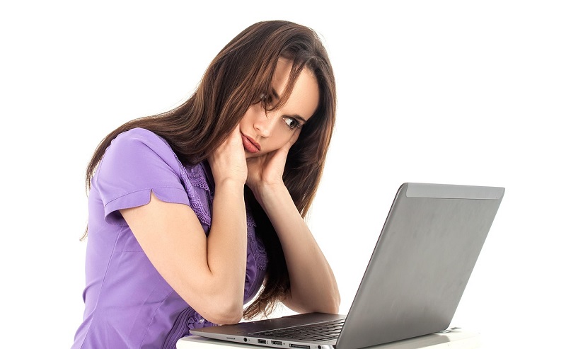 woman hunched over laptop