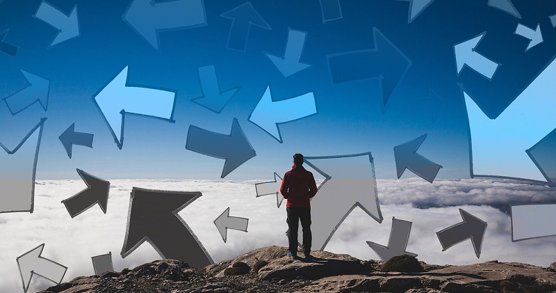 a man looking at a bunch or arrows pointing in different directions