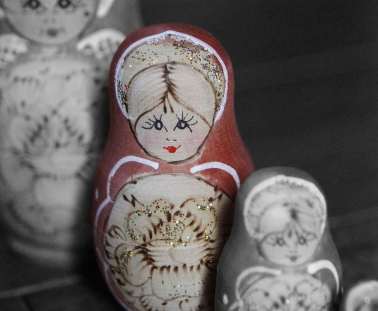 Russian nesting dolls; one is in color; the rest are black and white.