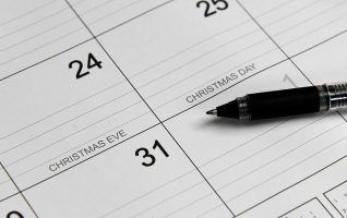 a day calendar with a pen