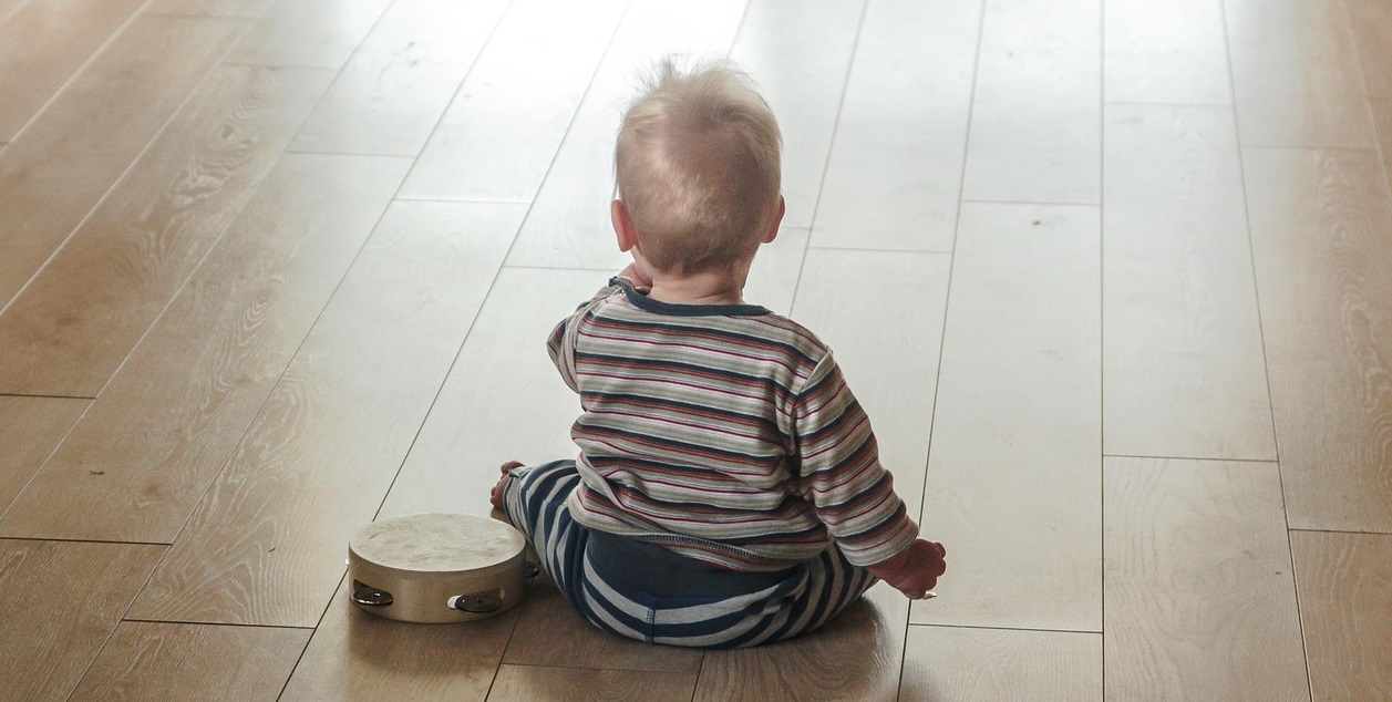 young child sitting on the floor