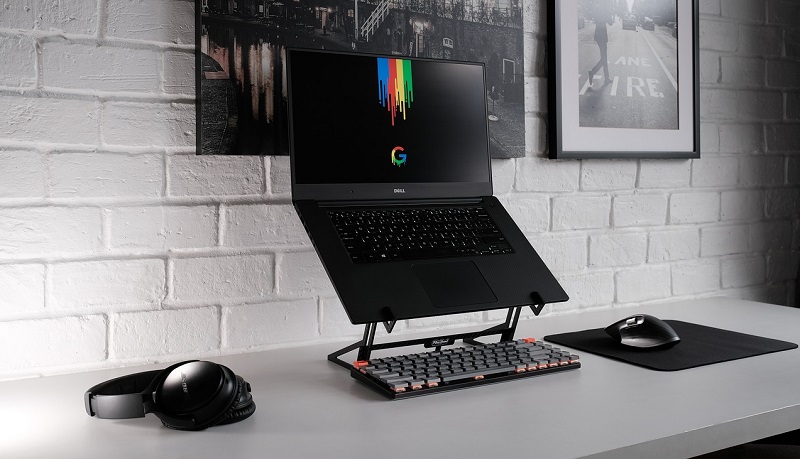 laptop on a stand with a wireless keyboard and mouse