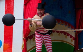 circus strongman lifting barbell