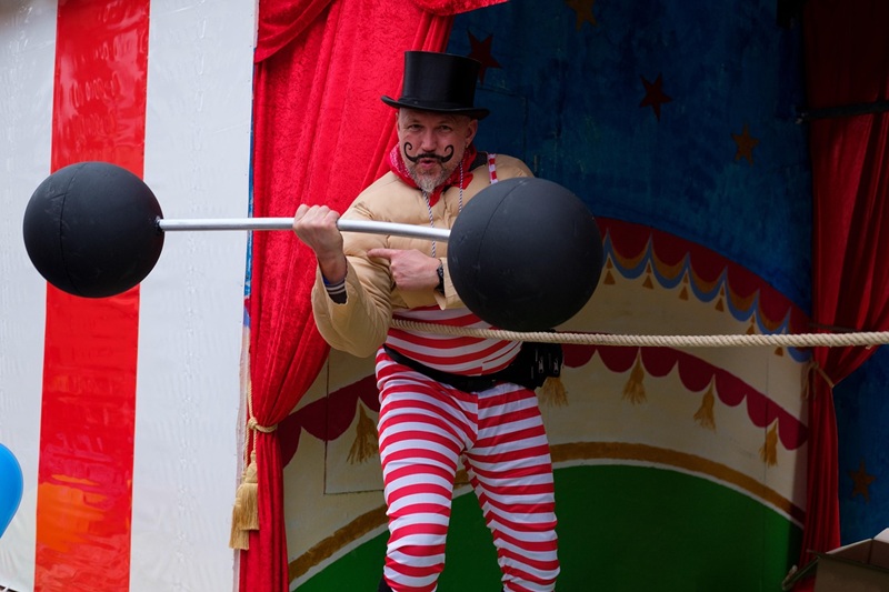 circus strongman lifting barbell